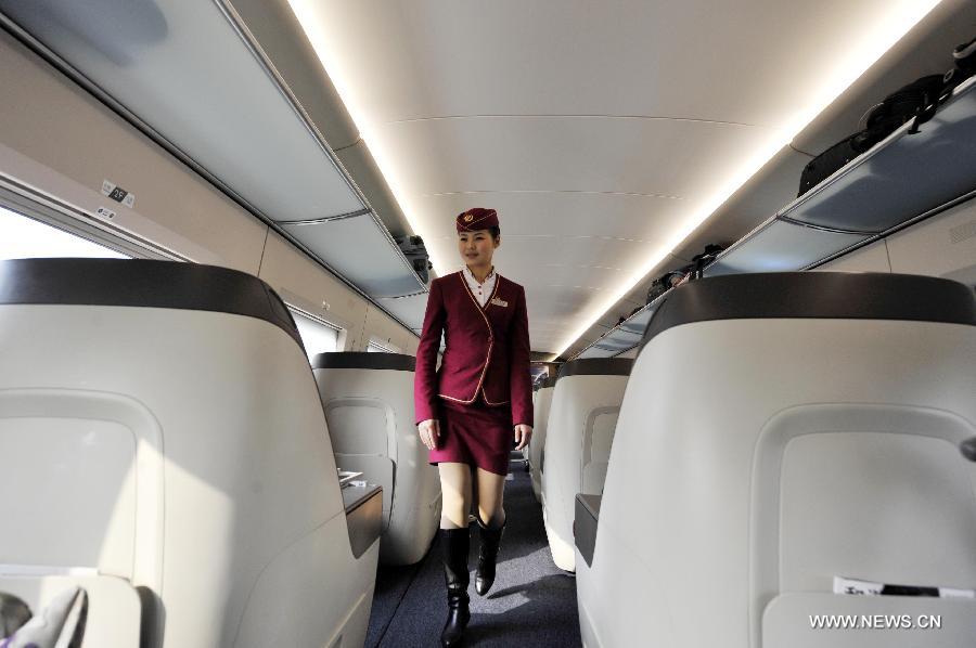 A stewardess walks through a bussiness class section of G80 express train during a trip to Beijing, capital of China, Dec. 22, 2012.
