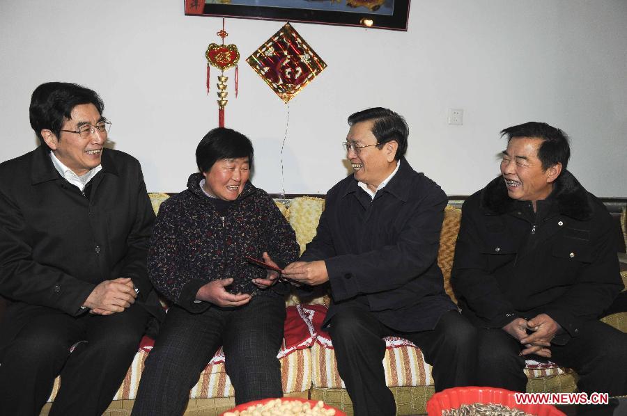 File photo taken on Jan. 18, 2012 shows Zhang Dejiang (2nd, R) visits residents during a study tour on urban and rural pension insurance systems in Beijing, capital of China. (Xinhua/Rao Aimin) 