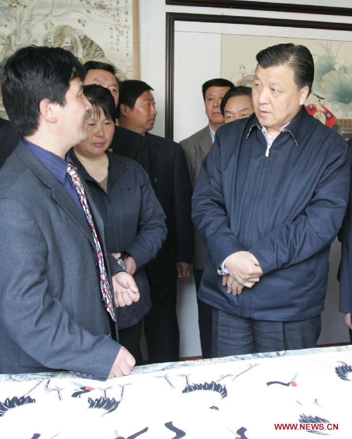 In this file photo taken on April 7, 2007, Liu Yunshan (R, front) learns about villagers' involvement in the artistic painting industry as he visits the studio of Wang Jianmin, a village painter who excels in drawing tigers, during an investigation and research tour in Wanggongzhuang Village of Minquan County, central China's Henan Province. (Xinhua/Cui Shenyi) 