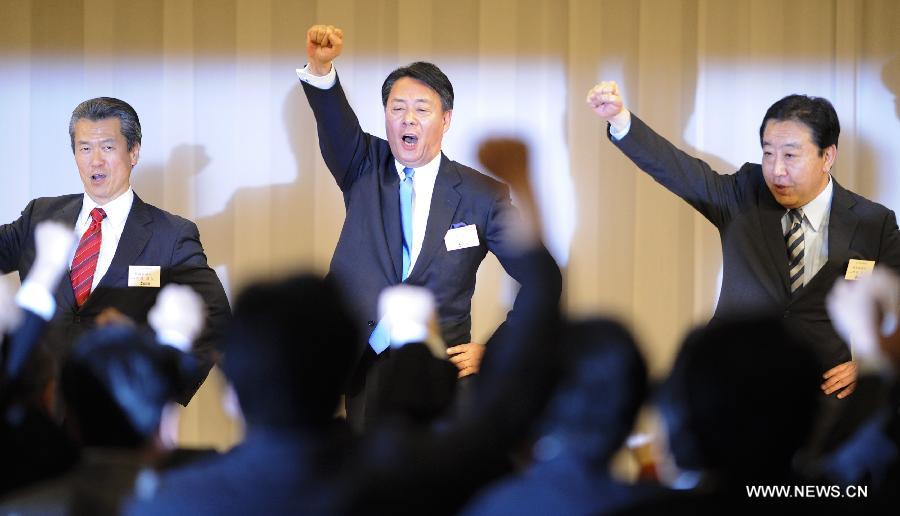 Banri Kaieda (C), new leader of the Democratic Party of Japan (DPJ) and former trade minister, raises his fist with outgoing prime minister Yoshihiko Noda (R) and former transport minister Sumio Mabuchi after the leadership election of DPJ in Tokyo, Dec. 25, 2012. Banri Kaieda on Tuesday became the new leader of the DPJ. (Xinhua/Kenichiro Seki)  