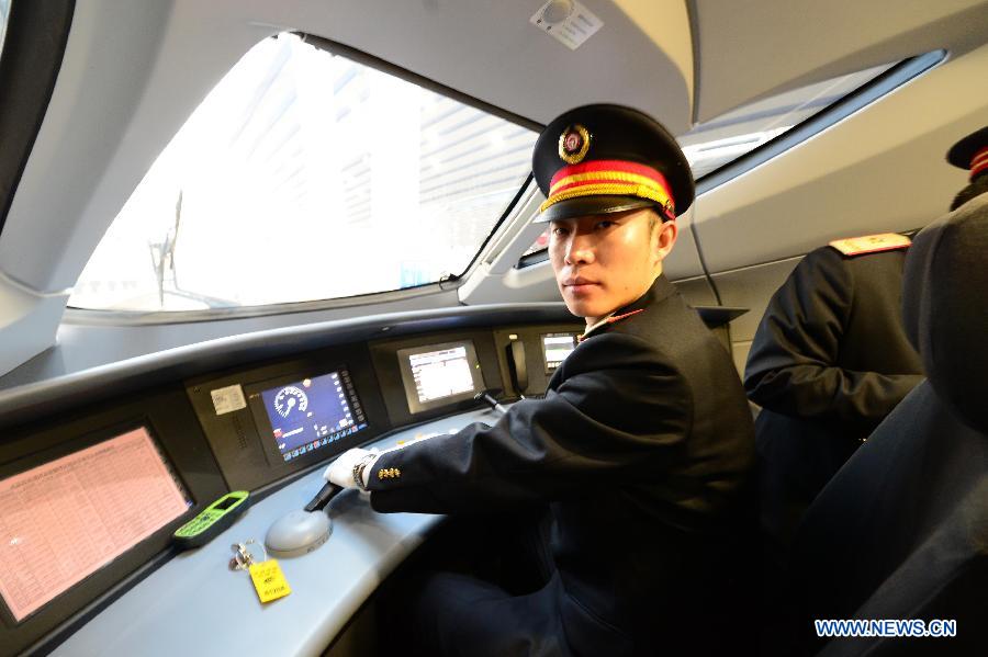 Driver Zhang Xi prepares to operate bullet train G801 to leave the Beijing West Railway Station in Beijing, capital of China, for Guangzhou, capital of south China's Guangdong Province, Dec. 26, 2012. (Xinhua/Zhou Guoqiang)