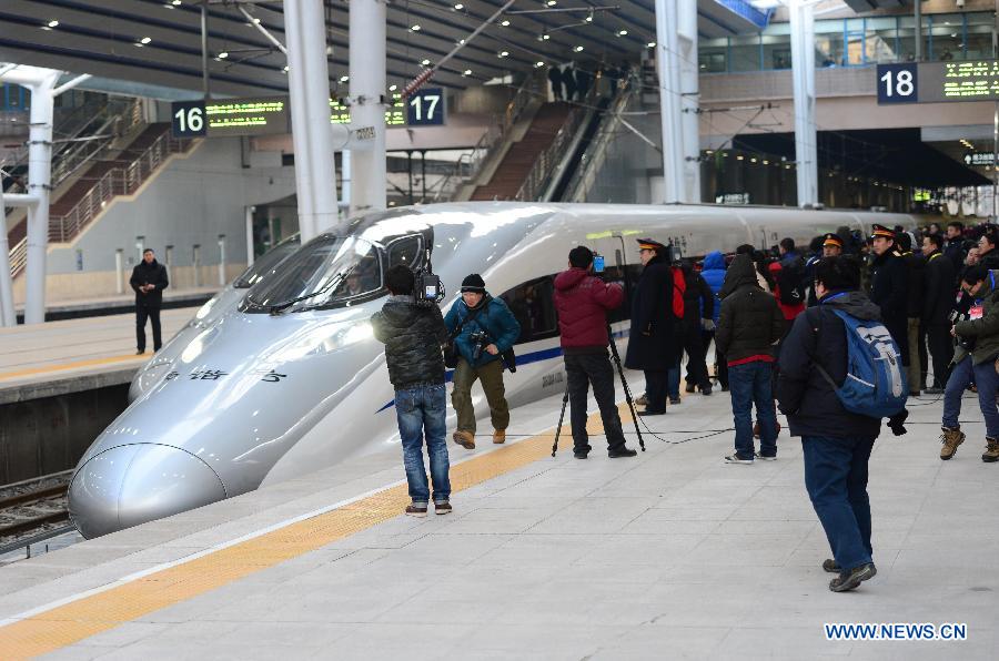 Bullet train G801 leaves the Beijing West Railway Station in Beijing, capital of China, for Guangzhou, capital of south China's Guangdong Province, Dec. 26, 2012. The world's longest high-speed rail route linking Beijing and Guangzhou started operation on Wednesday. (Xinhua/Zhou Guoqiang)