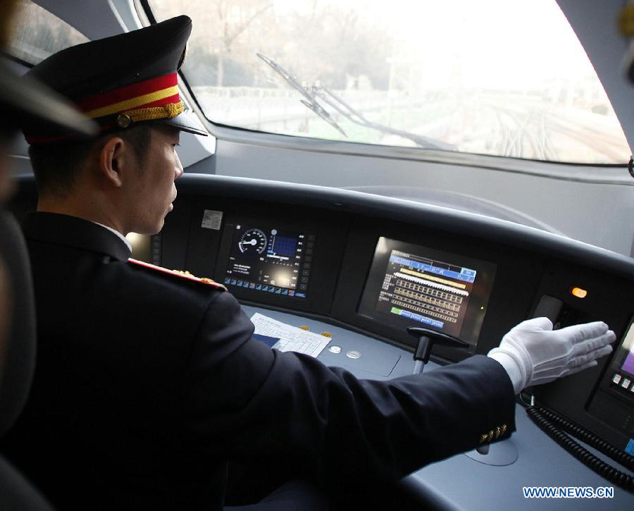 A driver operates bullet train G801 to leave for Guangzhou, capital of south China's Guangdong Province, from the Beijing West Railway Station in Beijing, capital of China, Dec. 26, 2012.(Xinhua/Wang Shen)  