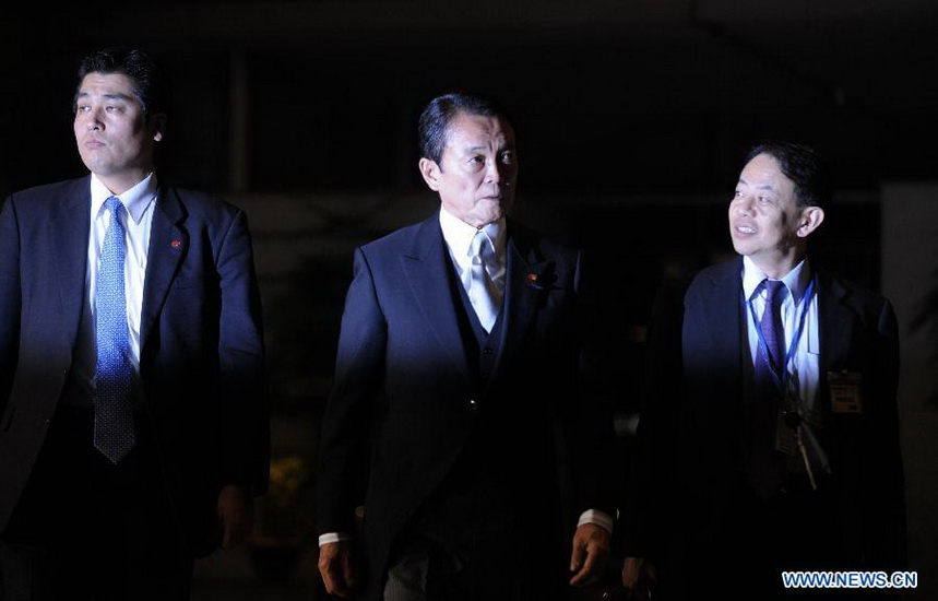 Former Prime Minister Taro Aso (C), vice prime minister, financial minister and financial services minister, arrives at the prime minister's official residence in Tokyo, Japan, Dec. 26, 2012. Japan's new Chief Cabinet Secretary Yoshihide Suga on Wednesday announced members of a new cabinet led by Prime Minister Shinzo Abe, who just claimed the post in a special session of the Diet. (Xinhua/Kenichiro Seki) 