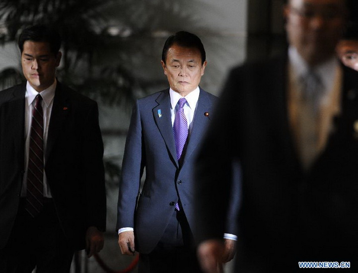 Former Prime Minister Taro Aso (C), vice prime minister, financial minister and financial services minister, arrives at the prime minister's official residence in Tokyo, Japan, Dec. 26, 2012. Japan's new Chief Cabinet Secretary Yoshihide Suga on Wednesday announced members of a new cabinet led by Prime Minister Shinzo Abe, who just claimed the post in a special session of the Diet. (Xinhua/Kenichiro Seki) 