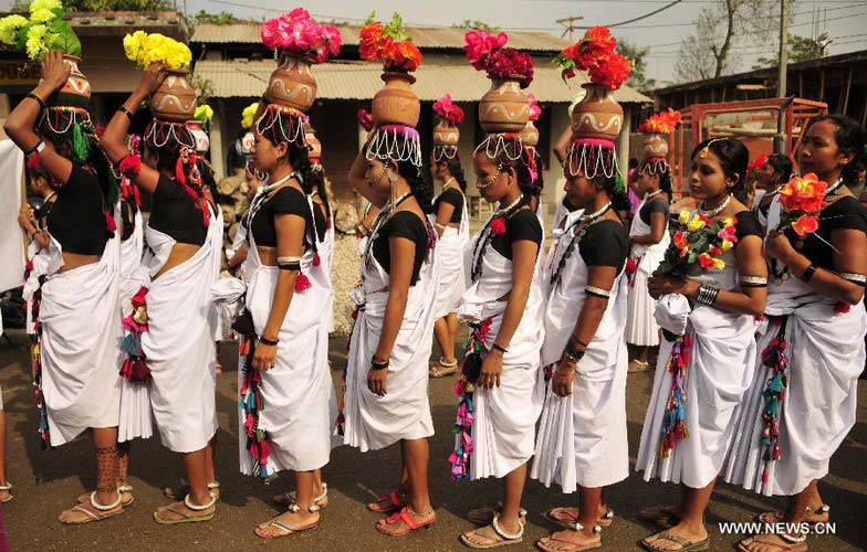 Tharu women participate in the opening ceremony of the 9th International Elephant Festival in Sauraha of Chitwan district, Nepal, Dec. 26, 2012. The festival was organized to promote the tourism and to make awareness of elephant conservation in Nepal. (Xinhua/Sunil Pradhan) 