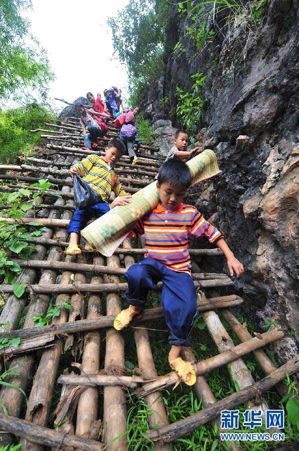 Growth is achieved by arduous road: Students walk along steep wooden steps, which is essential on their way to school, Dahua Yao Autonomous County, Guangxi Zhuang Autonomous Region, Sept. 3, 2012. (Xinhua/Huang Xiaobang)