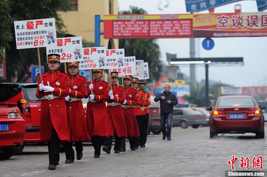 Staff dress up as military soldiers parade on a street to publicize the new traffic regulation which has taken effect since Jan. 1, 2013. (Xinhua/Chen Chao)