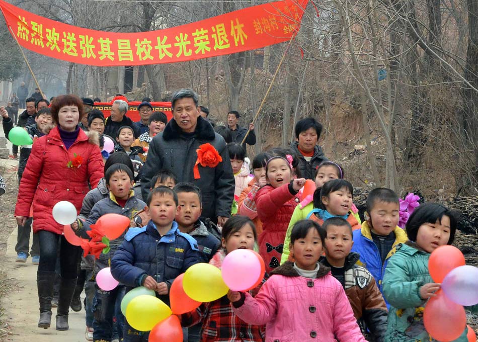 Students, teachers and villagers from Fenggou village of Luoyang of Henan province hold a ceremony for the retirement of Zhang, a local teacher, on Feb. 26, 2012. Zhang Qichang was an ordinary primary school teacher who served for 40 years. He has taught more than 1,000 students, of which more than 80 entered colleges. (Xinhua/Wang Song)