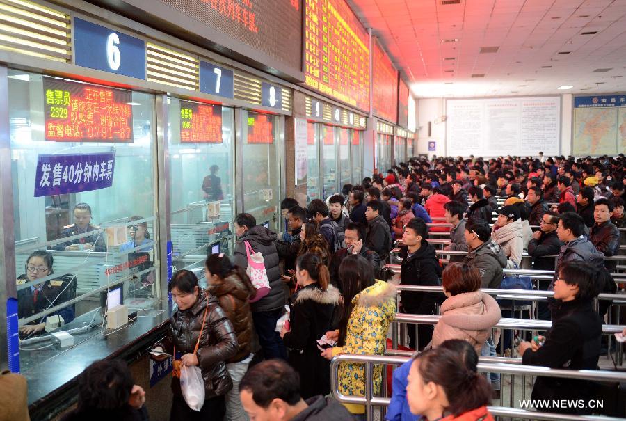 People line to buy railway tickets at Nanchang Railway Station in Nanchang, capital of east China's Jiangxi Province, Jan. 9, 2013. The tickets for the upcoming Spring Festival rush period can be purchased at ticket offices and agencies since Jan. 9. The 40-day 2013 Spring Festival travel rush will start on Jan. 26. The Spring Festival for family reunions begins from the first day of the first month of the traditional Chinese lunar calendar, or Feb. 10, 2013. (Xinhua/Zhou Ke) 