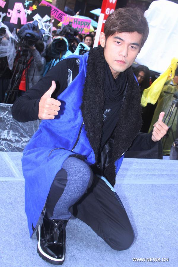 Pop singer Jay Chou poses for photos at an autograph session promoting his new album "Opus 12", in Taipei, southeast China's Taiwan, Jan. 12, 2013. (Xinhua) 