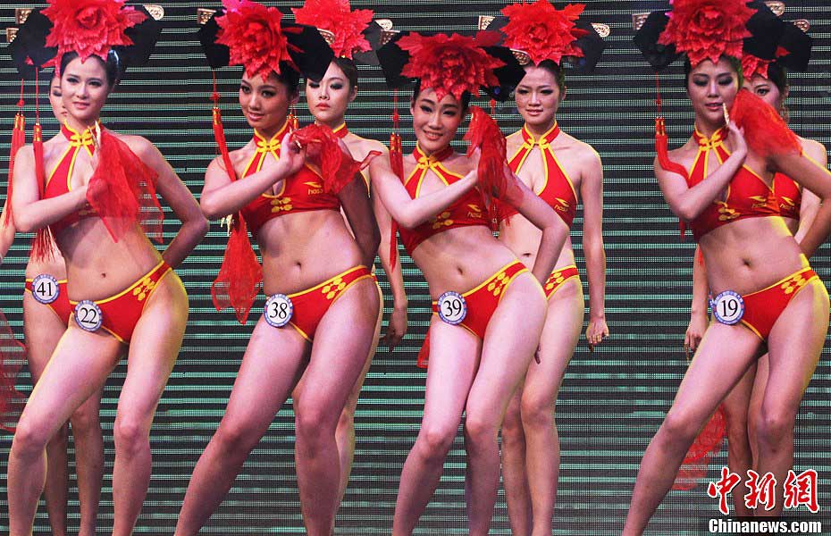 Contestants wearing Chinese style bikinis perform at the China final of the 37th Miss Bikini International Competition in Zhaoqing, south China's Guangdong Province, Jan. 12, 2013. Nearly 30 girls took part in the China final on Saturday. (CNSPHOTO/Qian Xingqiang)