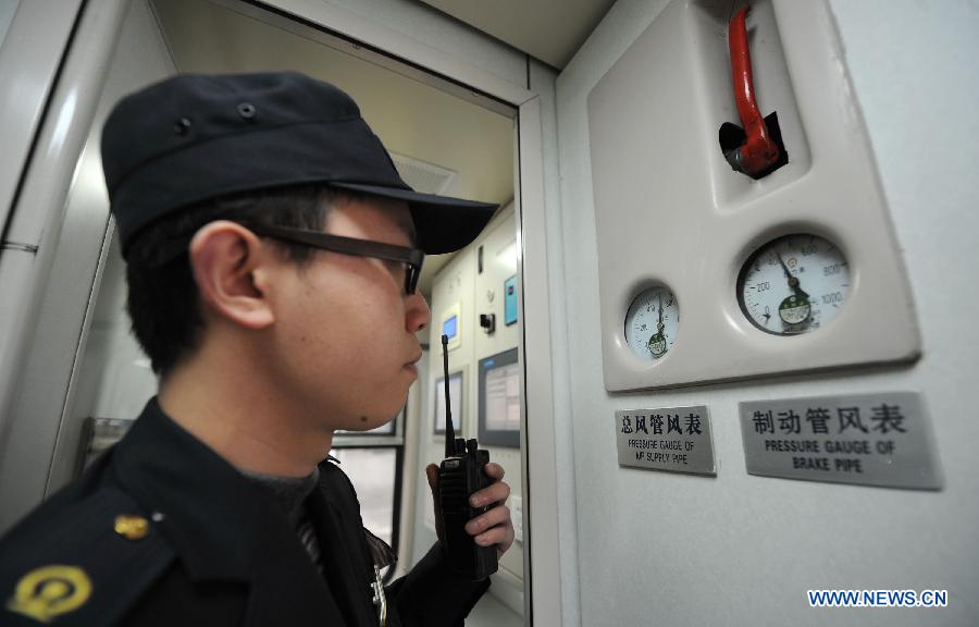 A staff member checks meters on the Z124/Z122 express sleeper train from Chengdu to Shanghai in Chengdu, capital of southwest China's Sichuan Province, Jan. 15, 2013. The Z124/Z122 train from Chengdu to Shanghai, which started operation on Tuesday, is the first express sleeper train in southwest China and the fastest among all trains running between Chengdu and Shanghai. (Xinhua/Xue Yubin)