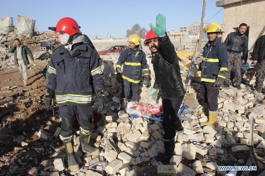 Rescuers inspect the site of bomb attack in Kirkuk, Iraq, on Jan. 16, 2013. Up to 17 people were killed and 133 wounded in two bomb attacks targeting offices of Kurdish parties in the ethnically mixed cities of Kirkuk and Tuz-Khurmato in northern Iraq on Wednesday, according to the police. (Xinhua/Dina Assad)