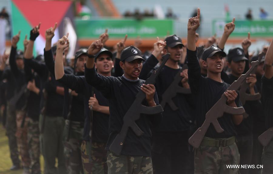 Palestinian high school students attend a graduation ceremony of a military school course organized by the Hamas security forces and the Hamas Minister of Education in Gaza City, on Jan. 24, 2013. (Xinhua/Wissam Nassar)  
