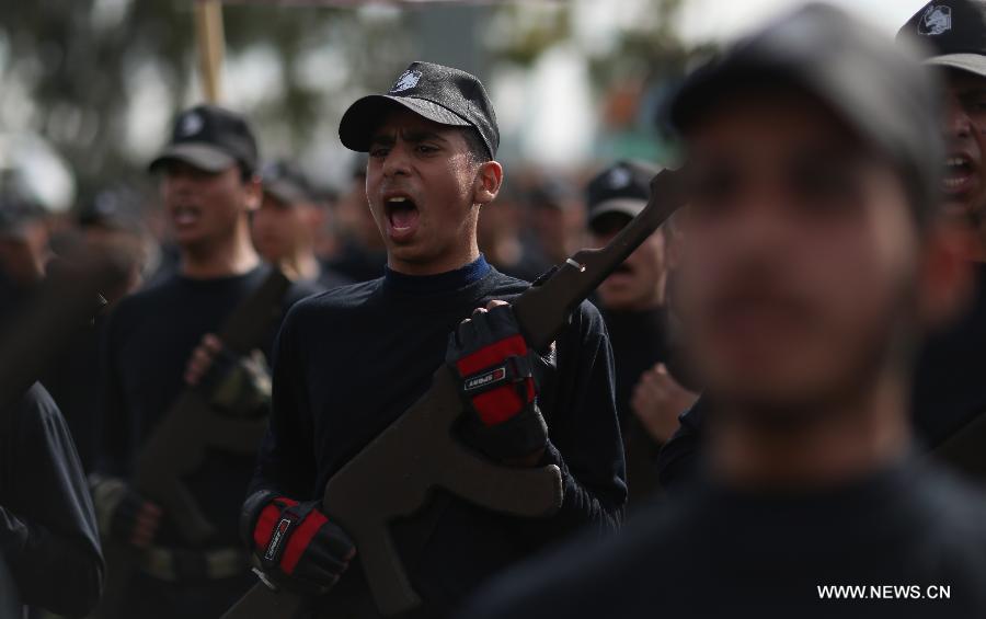 Palestinian high school students attend a graduation ceremony of a military school course organized by the Hamas security forces and the Hamas Minister of Education in Gaza City, on Jan. 24, 2013. (Xinhua/Wissam Nassar)  