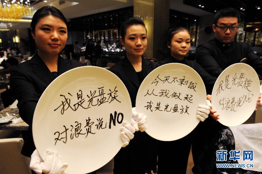 Staff members of a restaurant launch a campaign encouraging consumers to avoid food waste in Qingdao, Shandong province, Jan. 24.  Stirred by an exposure on astonishing food waste on Chinese tables, “Did you empty the dishes today?” has become the most popular question in China. As response, restaurants and government departments take actions to eliminate food waste. Showing an empty dish also turns a new fashion among Chinese netizens.  (Xinhua/Li Ziheng) 