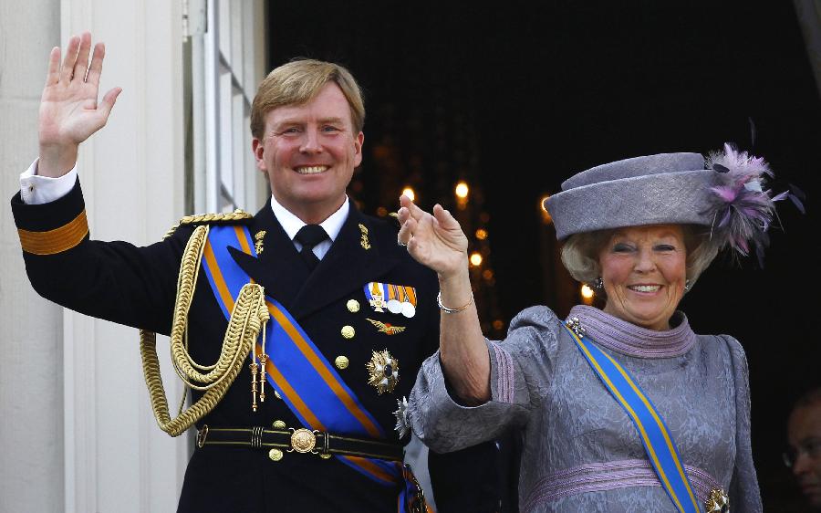 In this file photo Dutch Queen Beatrix, right, and Dutch Crown Prince Willem-Alexander, left, wave to wellwishers from the balcony of Royal Palace Noordeinde after the Queen officially opened the new parliamentary year in The Hague, Netherlands.(Xinhua/Reuters)