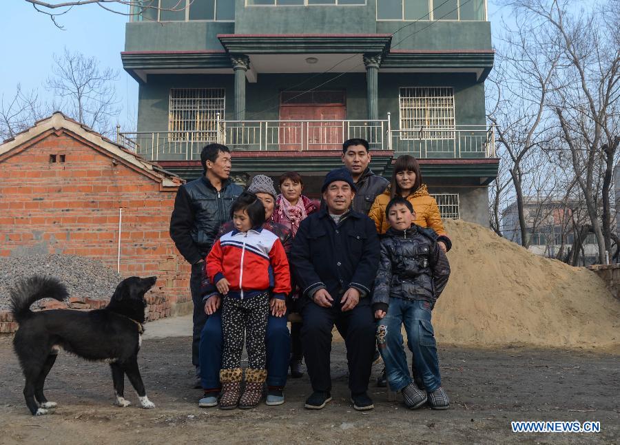 Liu Chuantao (2nd R, Back) poses for a family photo after arriving at home in Fuyang of east China's Anhui Province, Jan. 29 , 2013. Liu Chuantao, a 32-year-old migrant worker, runs a business of home decorations in Hangzhou, capital of east China's Zhejiang Province. His wife, Chen Yan, works for a Hangzhou based factory. The couple brought their eight-year-old daughter Liu Pingping to Hangzhou while leaving their elder son Liu Zhen attending a school in their hometown in Fuyang. As the Spring Festival draws near, Liu Chuantao took the L8600 train from Hangzhou to Fuyang in the evening of Jan. 28, 2013, together with his wife and daughter. After more than 12 hours' travel on trains and buses, the family finally got reunited on Jan. 29, 2013 after a year's separation. (Xinhua/Huang Zongzhi) 