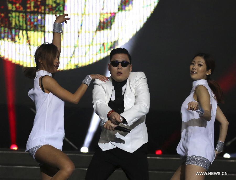 South Korean singer Psy dances as he sings his hit single "Gangnam Style" during a concert at Nanjing Olympic Sports Center in Nanjing, capital of east China's Jiangsu Province, Feb. 2, 2013. It is the first time for Psy to participate in commercial performance on the Chinese mainland. (Xinhua/Yan Minhang)
