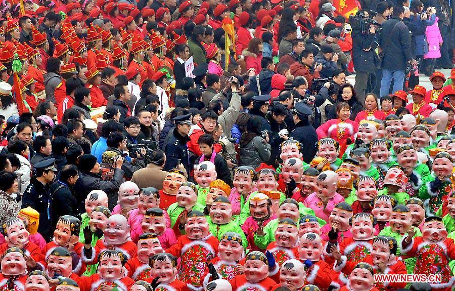 Art troupes and people gather to participate in a New Year parade in Zhengzhou, capital of central China's Henan Province, Feb. 14, 2010. Parades participated by local art troupes can be seen in several places in Henan during the Spring Festival or Chinese Lunar New Year period. (Xinhua/Wang Song)