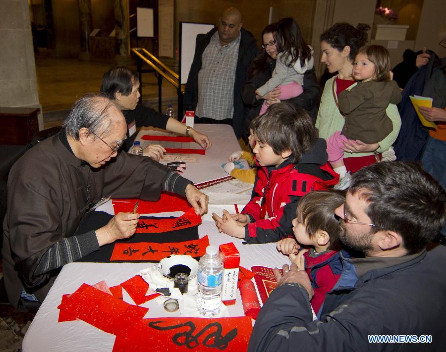 Calligraphers write greetings and visitors' Chinese names in Chinese calligraphy demonstration during the Chinese Cultural Heritage Day event at the Royal Ontario Museum in Toronto, Canada, Feb. 2, 2013. One of the most prominent museums in the Canadian city of Toronto was transformed into a galore of Chinese artistry on Saturday, presenting a live snake display, an ethnic costume display and a diverse array of Chinese-themed performances. (Xinhua/Zou Zheng)