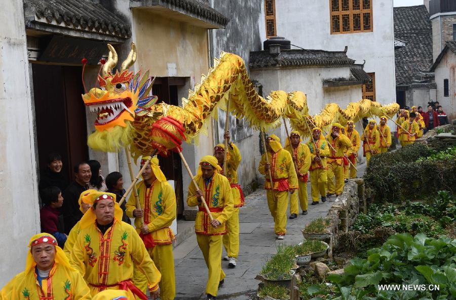 Performers walk with a dragon lantern in Jiangwan Village of Wuyuan County, east China's Jiangxi Province, Feb. 4, 2013. Various traditional activities were held in Wuyuan to celebrate "Lichun", literally meaning the beginning of the spring, as well as the Xiaonian Festival which falls on the 23rd or 24th day of the 12th month of the Chinese traditional lunar calendar. (Xinhua/Song Zhenping)