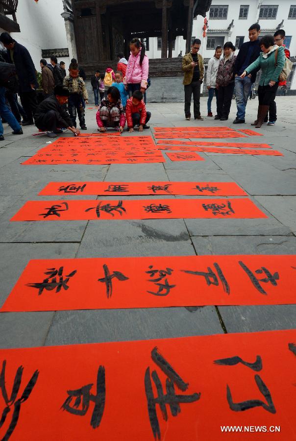 Calligraphy enthusiasts write Spring Festival Couplets in Jiangwan Village of Wuyuan County, east China's Jiangxi Province, Feb. 4, 2013. Various traditional activities were held in Wuyuan to celebrate "Lichun", literally meaning the beginning of the spring, as well as the Xiaonian Festival which falls on the 23rd or 24th day of the 12th month of the Chinese traditional lunar calendar. (Xinhua/Song Zhenping)