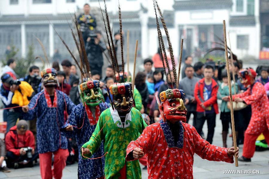 Villagers perform Nuo Dance, a traditional Chinese dance art, in Jiangwan Village of Wuyuan County, east China's Jiangxi Province, Feb. 4, 2013. Various traditional activities were held in Wuyuan to celebrate "Lichun", literally meaning the beginning of the spring, as well as the Xiaonian Festival which falls on the 23rd or 24th day of the 12th month of the Chinese traditional lunar calendar. (Xinhua/Song Zhenping)