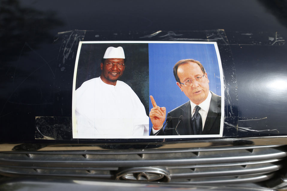 Pictures of Mali's interim President Dioncounda Traore and France's President Francois Hollande are seen on a car in the town center of Timbuktu on Feb. 1, 2013.(Xinhua News Agency/Reuters)