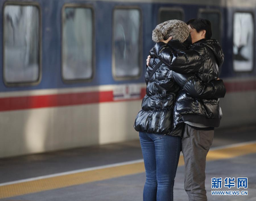 A couple kisses before seperation at the platform of Beijing Railway Station on Jan. 26, 2013. (Xinhua/Wang Shen)
