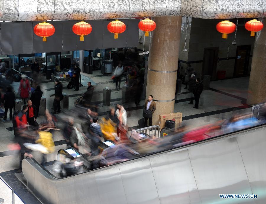 Passengers take elevator at the Zhengzhou Railway Station in Zhengzhou, capital of central China's Henan Province, Feb. 5, 2013. China's transport system sees an annual travel rush around the Spring Festival, which starts on Feb. 10 this year. (Xinhua/Li Bo)