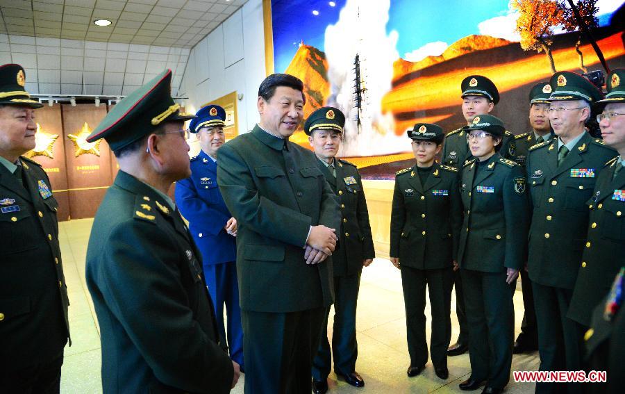 Xi Jinping (C), general secretary of the Communist Party of China (CPC) Central Committee and chairman of the CPC Central Military Commission (CMC), talks with technical personnel and army members at the Jiuquan Satellite Launch Center on Feb. 2, 2013. Xi Jinping visited troops stationed in the nation's northwest ahead of the lunar new year, extending festival greetings and stressing frugality in the army. (Xinhua/Li Gang)