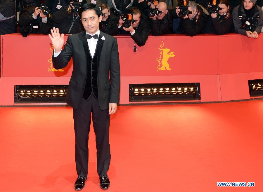 Chinese actor Tony Leung poses on the red carpet upon arrival for the opening ceremony of the 63rd Berlin film festival in Berlin, Germany, on Feb. 7, 2013. The 63rd Berlin film festival opened Thursday with a martial arts epic "The grandmaster" of Chinese director Wong Kar Wai who will also lead the jury of this Berlinale. (Xinhua/Ma Ning)