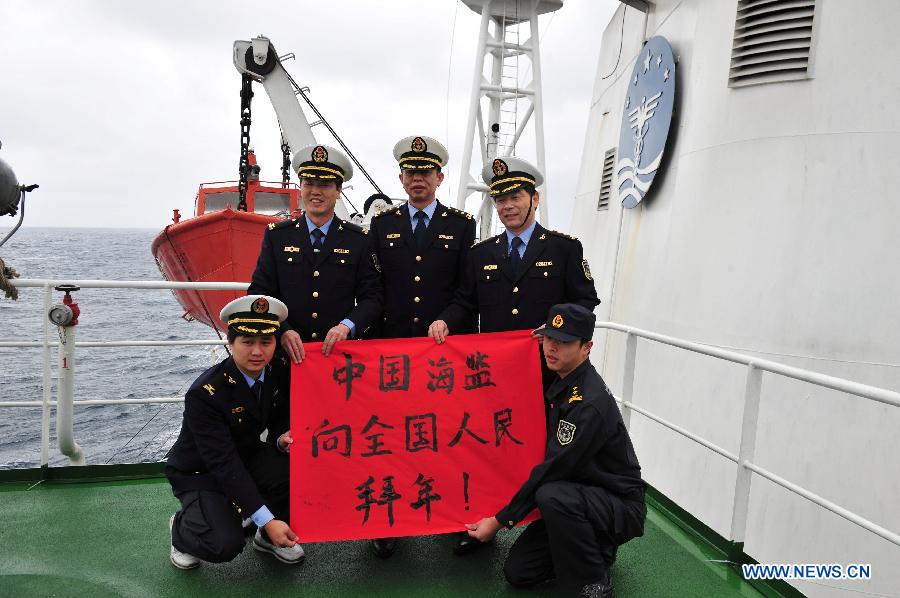 Crew members aboard the Haijian 137, a Chinese marine surveillance ship, extend their Spring Festival greetings to the Chinese people during a patrol mission in the territorial waters surrounding the Diaoyu Islands in the East China Sea on Feb. 10, 2013. A Chinese marine surveillance fleet, which includes the Haijian 50, Haijian 51, Haijian 66 and Haijian 137 ships, carried out regular patrol missions in the territorial waters surrounding the Diaoyu Islands on Sunday, the first day of the 2013 Spring Festival. (Xinhua/Zhang Jiansong)