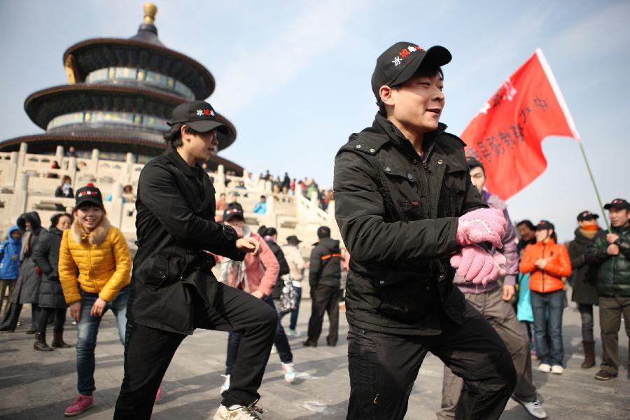 Youngsters perform Gangnam Style dance in the Temple of Heaven in Beijing, China, Feb. 10, 2013. People in China are enjoying the week-long holiday of Spring Festival, or Chinese Lunar New Year. Numerous travelers has crammed in tourism sites across the country. (Xinhua/Liu Changlong) 