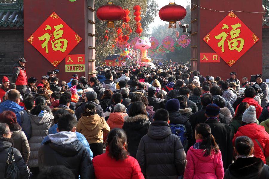 People visit a temple fair at the Temple of Earth in Beijing, China, Feb. 12, 2013. People in China are enjoying the week-long holiday of Spring Festival, or Chinese Lunar New Year. Numerous travelers has crammed in tourism sites across the country. (Xinhua/Pang Zhengzheng) 