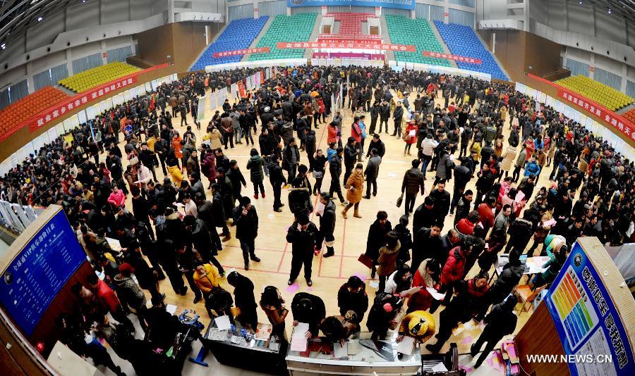 People attend a job fair in Jinhu County, east China's Jiangsu Province, Feb. 15, 2013. As the Spring Festival holiday draws to a close, various job hunting fairs are held among cities across the country. (Xinhua/Chen Yibao) 