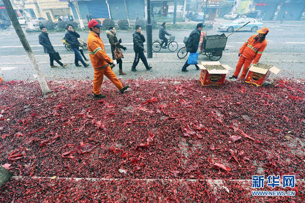 Street cleaning workers are trying to sweep away firework debris on a street in Hangzhou, eastern China's Zhejiang province, Saturday morning, February 16, 2013. Firework sprees are staged in many places around China on Saturday morning, the first workday after this year's Spring Festival holidays. Many Chinese businessmen pray this way for a properous new year, but such activities have also been blamed for burdening cleaning workers and worsening air pullution. (Photo/Xinhua) 