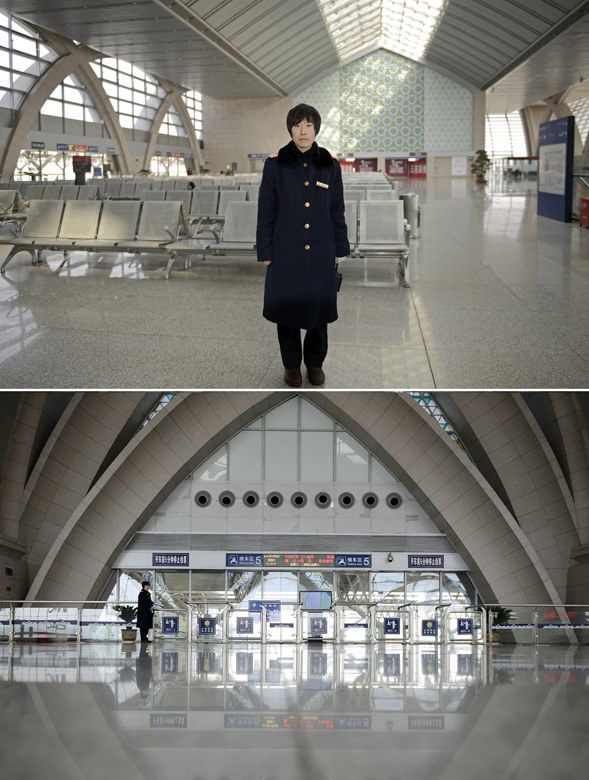 Wang Jiao works in the Yinchuan Railway Station on Feb. 9, 2013. It was the fifth year that Wang spent the Spring Festival on working post. She has just become a mother and her baby was only six months old. (Xinhua/Wang Peng)