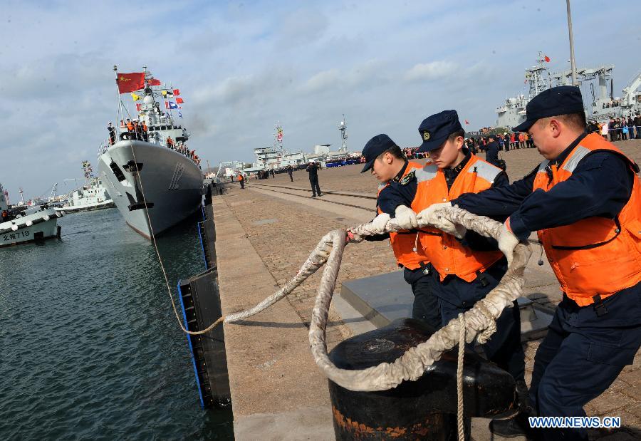 A missile destroyer "Harbin" sets sail at a port in Qingdao City, east China's Shandong Province, Feb. 16, 2013, to depart for the Gulf of Aden and the sea off Somalia on escort missions. The flotilla, as the 14th batch of its kind to engage in escort missions, consists of a missile destroyer and a frigate as well as a supply ship which are all from the North Sea Fleet of the People's Liberation Army (PLA) Navy. (Xinhua/Li Ziheng) 