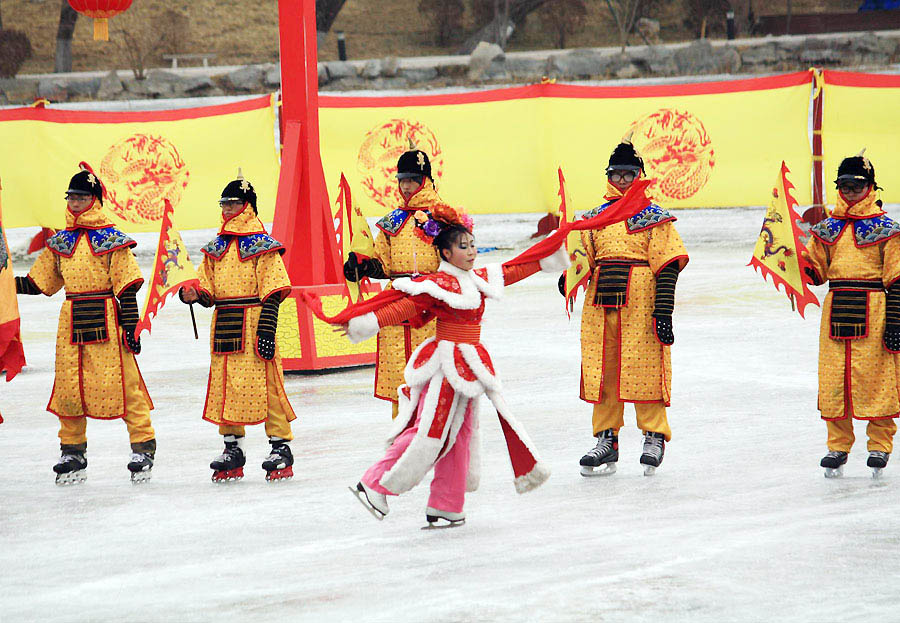 People wearing Qing dresses skate on ice. (PhotoChina/ Xiao Dong)