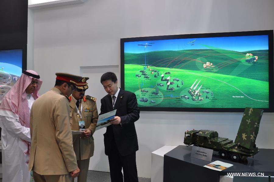 People visit the booth of China' defense giant China Poly Group Corp. during the Defense Exhibition and Conference (IDEX) 2013 in Abu Dhabi, the United Arab Emirates, Feb. 18, 2013. (Xinhua) 