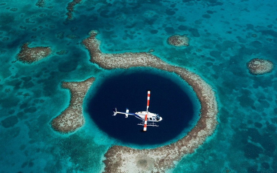 Blue Hole. A Blue Hole is basically a cave or underwater sinkhole. The hole appears in dark blue, because the blue cannot be absorbed by water, like the other colors in the spectrum. (Photo/Global Time) 