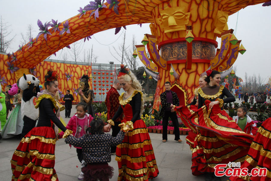 People in colorful costumes participate in a parade held to celebrate the Jinsha Sun Festival in Jinsha Village, Chengdu, Southwest China's Sichuan Province, February 20, 2013. Jinsha Village is home to the Jinsha Relics Museum, which, located at the Jinsha Archeological Site, is a theme park-style museum for the protection of, research into and display of Jinsha relics and archaeological finds. (CNS/Jin Sha)
