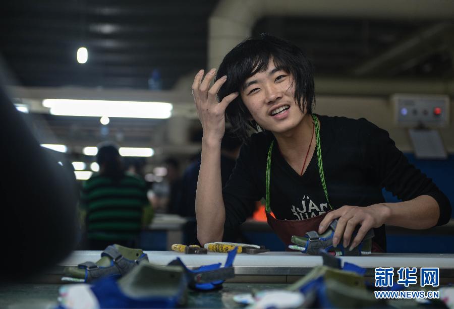 Fang Zhan, 19, works on a production line in a shoe factory in Wenling, Zhejiang on Feb. 17, 2013. Fang is a high school graduate from Henan; he got this job after Spring Festival holiday. (Xinhua/ Han Chuanhao) 