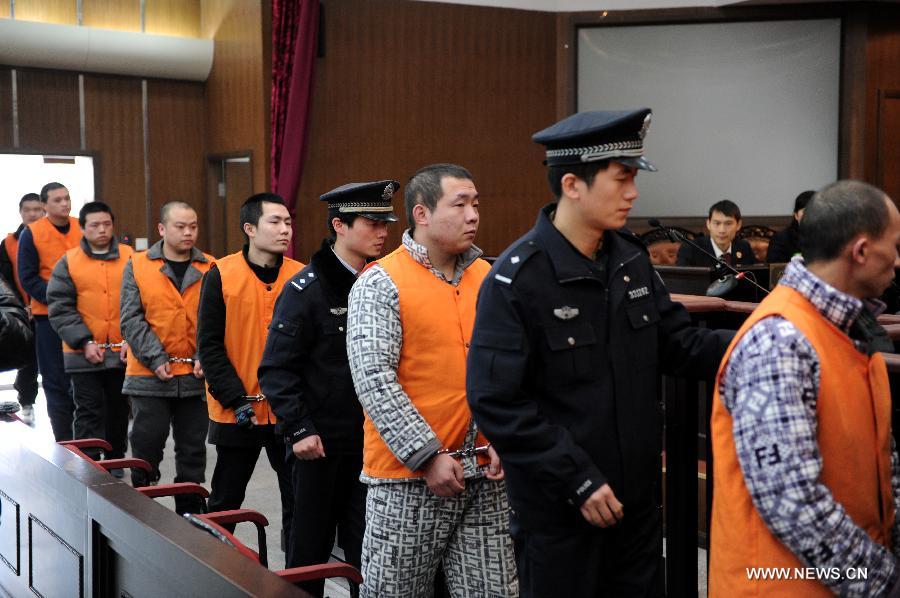 Defendants walk into the court to stand trial over kidney trafficking at the People's Court of Jianggan District in Hangzhou, capital of east China's Zhejiang Province, Feb. 21, 2013. Nine people, all under the age of 30, stood trial on Feb. 21 for kidney trafficking here. They recruited people who were willing to sell their kidneys and the kidney trafficking ring had recruited 38 people, 11 of whom sold their kidneys before the case was cracked by the Hangzhou police in May 2012. Traffickers could earn between 20,000 and 30,000 yuan (4,805 U.S. dollars) for each kidney. The nine should be prosecuted for the crime of organizing human organ trafficking, according to the procuratorate. The court will sentence the nine at a later date. (Xinhua/Ju Huanzong)