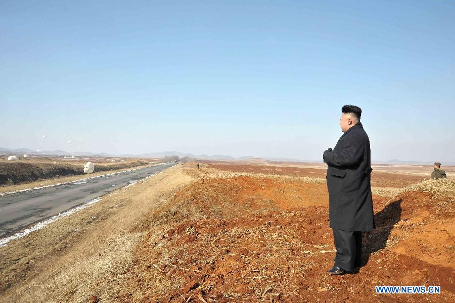 This undated picture released by Korean Central News Agency (KCNA) on Feb. 23, 2013 shows top leader of the Democratic People's Republic of Korea (DPRK) Kim Jong Un (L) watching a flight exercise and a paratrooping drill of the Air Force and Anti-Air Force and Large Combined Unit 630. (Xinhua/ Korean Central News Agency)