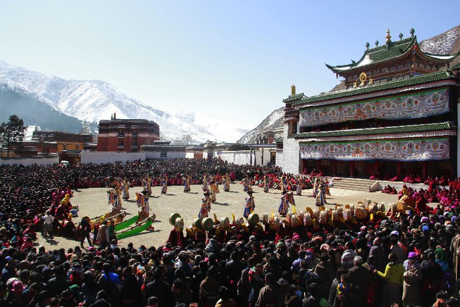 Buddhist monks perform a ritual dance to pray for good fortune and harvest at the Labrang Monastery in Xiahe County, Gannan Tibetan Autonomous Prefecture, northwest China's Gansu Province, Feb. 23, 2013. The Labrang Monastery is among the six great monasteries of the Geluk school of Tibetan Buddhism. (Xinhua/Shi Youdong)
