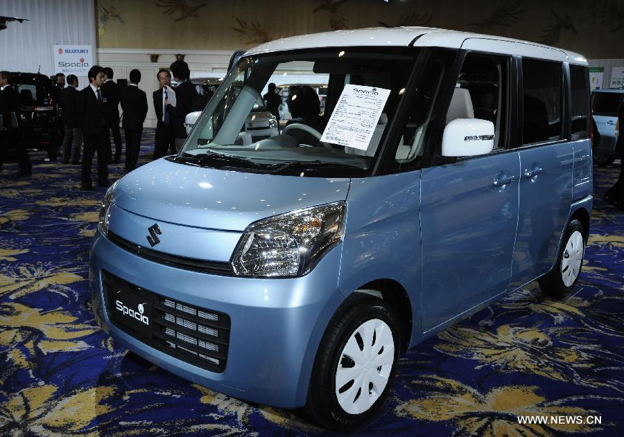 The new minicar "Spacia" of Japan's auto maker Suzuki Motor Osamu Suzuki is seen during a press conference in Tokyo, capital of Japan, on Feb. 26, 2013. Suzuki introduced the new mini car "Spacia" on Tuesday. (Xinhua/Kenichiro Seki) 